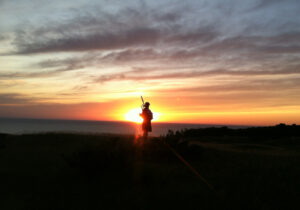 Arcadia Bluffs piper at sunset
