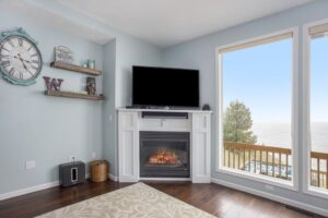 Curl up next to this cozy fireplace next to large open windows overlooking Lake Michigan and Make your next Christmas in Manistee One to Remember.