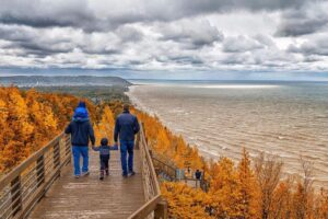 fall colors on walkway with water lake