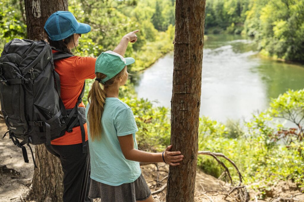mom and daughter looking out over the manistee river